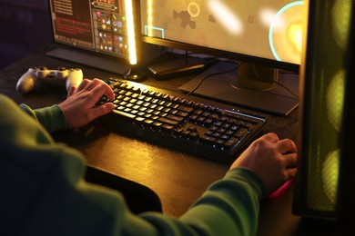 Man playing video games on computer indoors, closeup