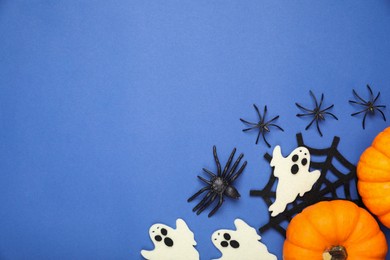 Flat lay composition with Halloween decor on blue background, space for text