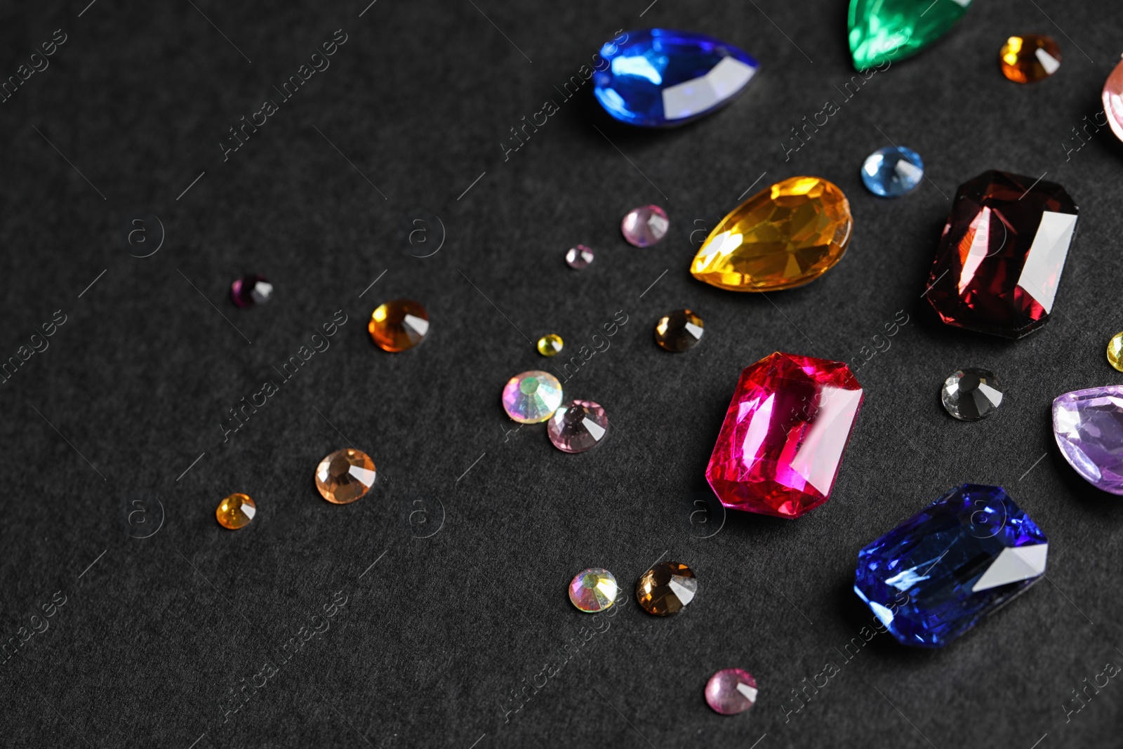 Photo of Beautiful gemstones for jewelry on dark background