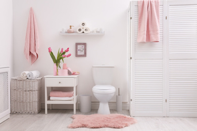 Photo of Interior of stylish bathroom with toilet bowl and decor elements