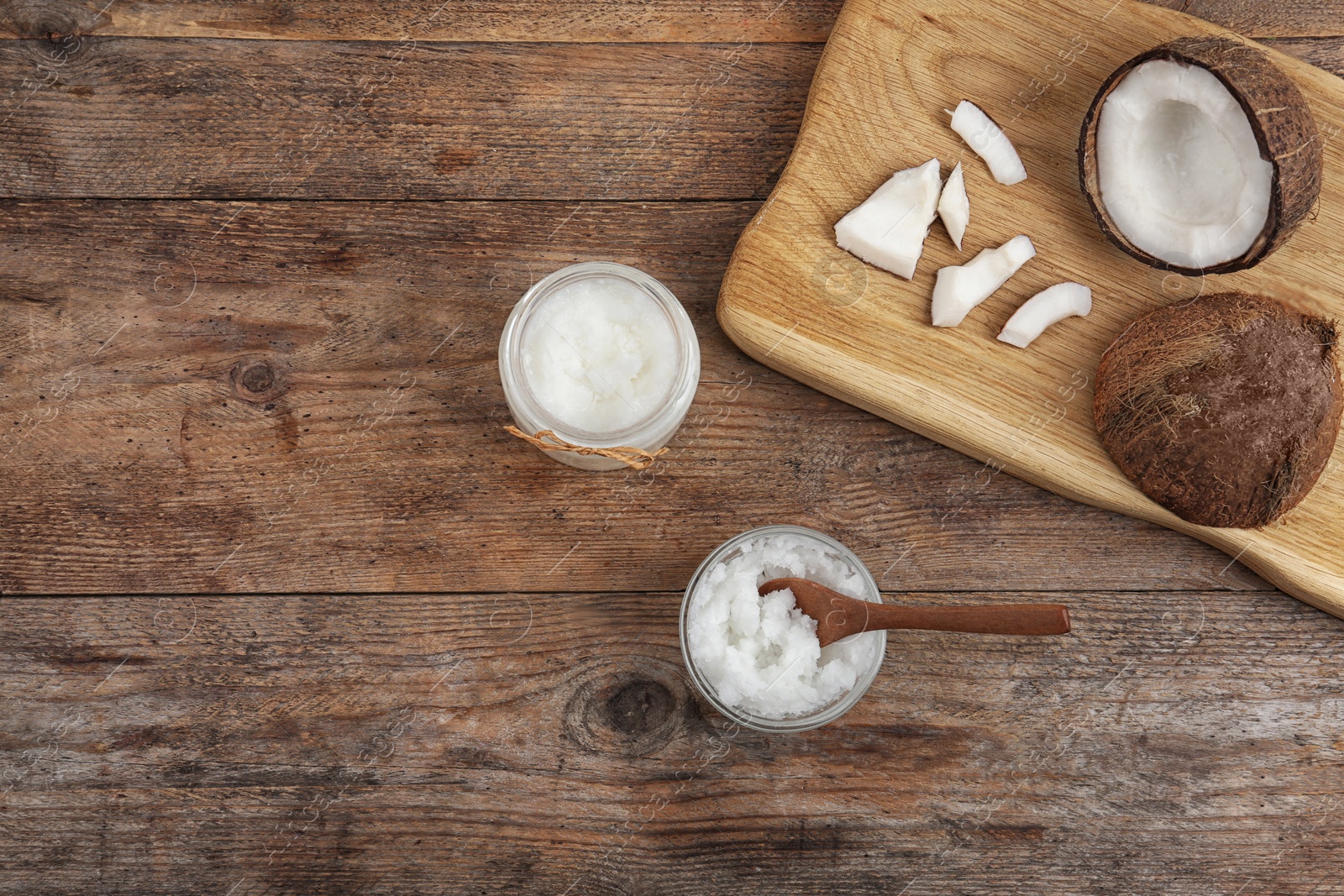 Photo of Flat lay composition with coconut oil on wooden table, space for text. Cooking ingredients