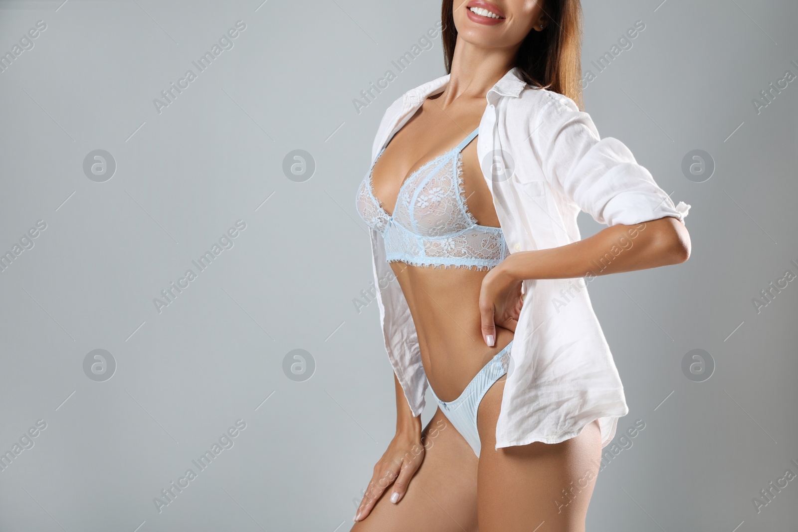 Photo of Woman in sexy panties on light grey background, closeup. Space for text