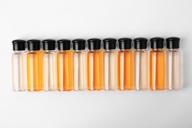 Bottles of cosmetic products on white background, flat lay