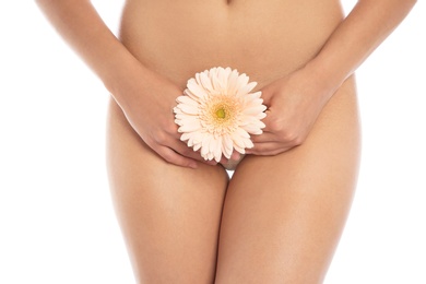 Photo of Young woman with flower showing smooth skin after bikini epilation on white background