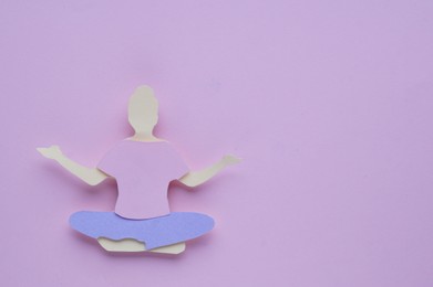Photo of Woman`s health. Paper female figure on light purple background, top view with space for text