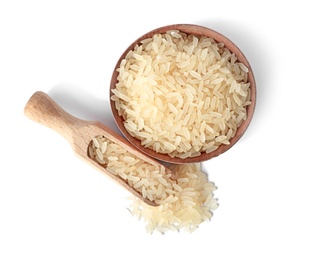 Photo of Bowl and scoop with uncooked parboiled rice on white background, top view
