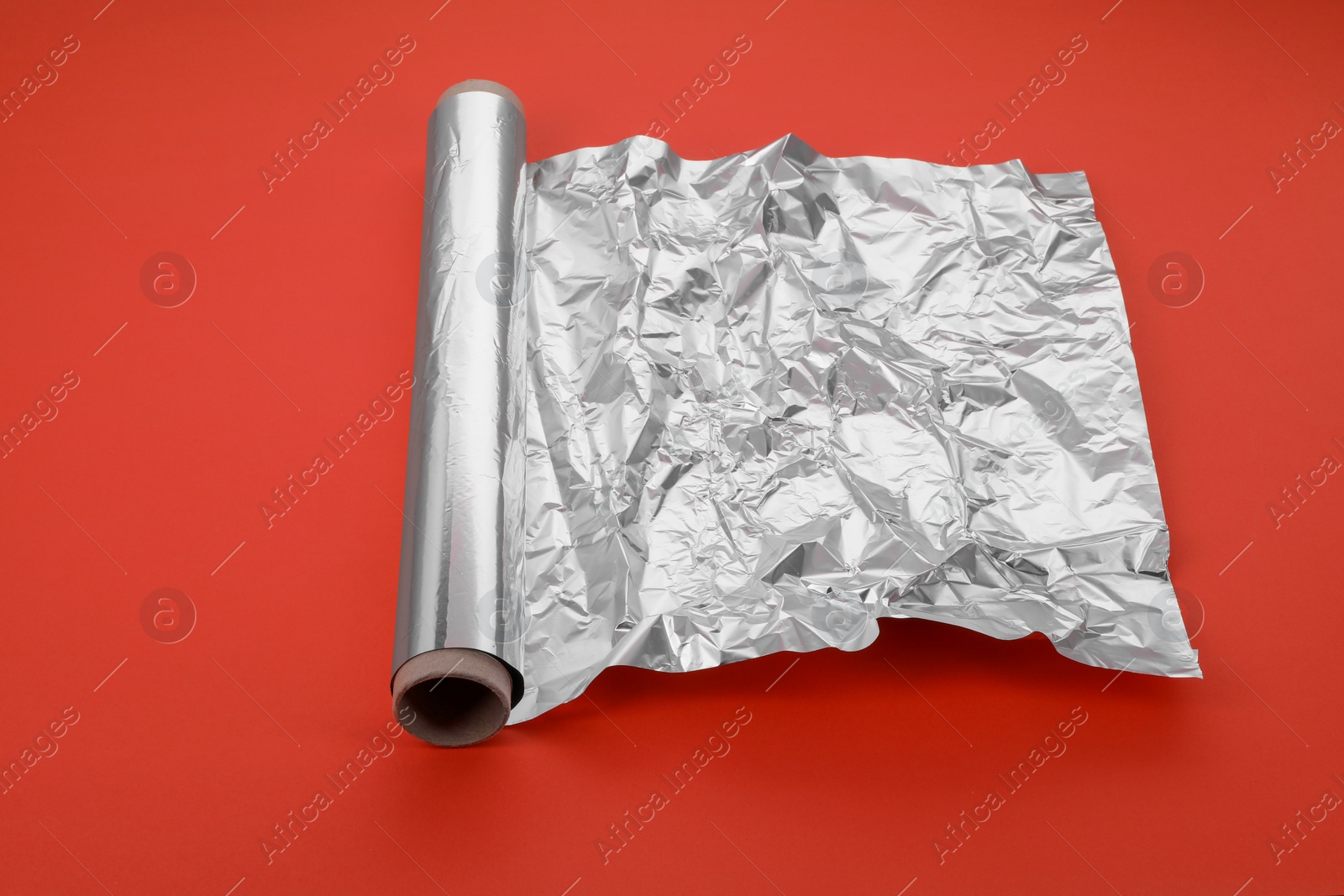 Photo of Roll of aluminum foil on orange background