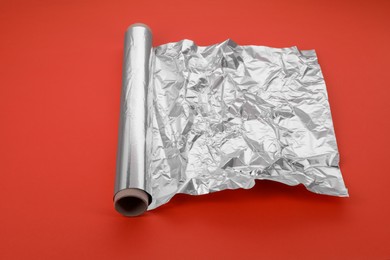 Roll of aluminum foil on orange background