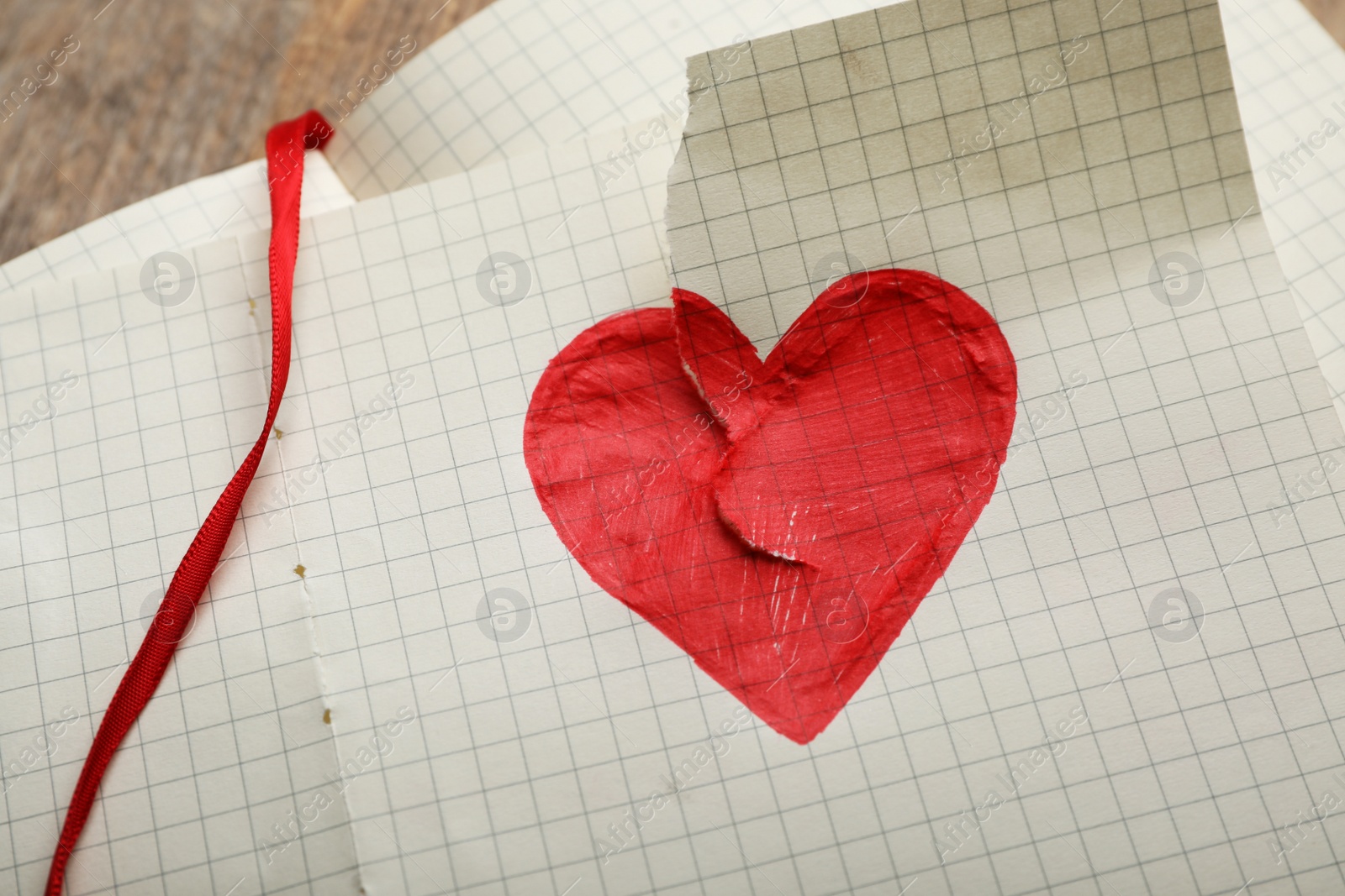 Photo of Torn paper with heart drawing, closeup. Relationship problems concept