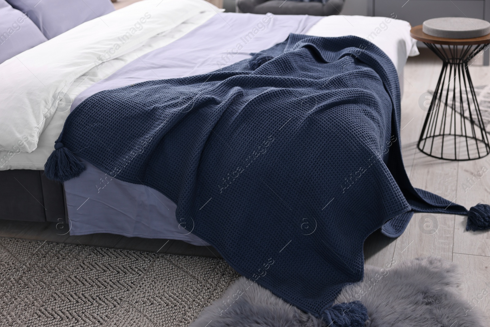 Photo of Soft blue plaid on bed in room