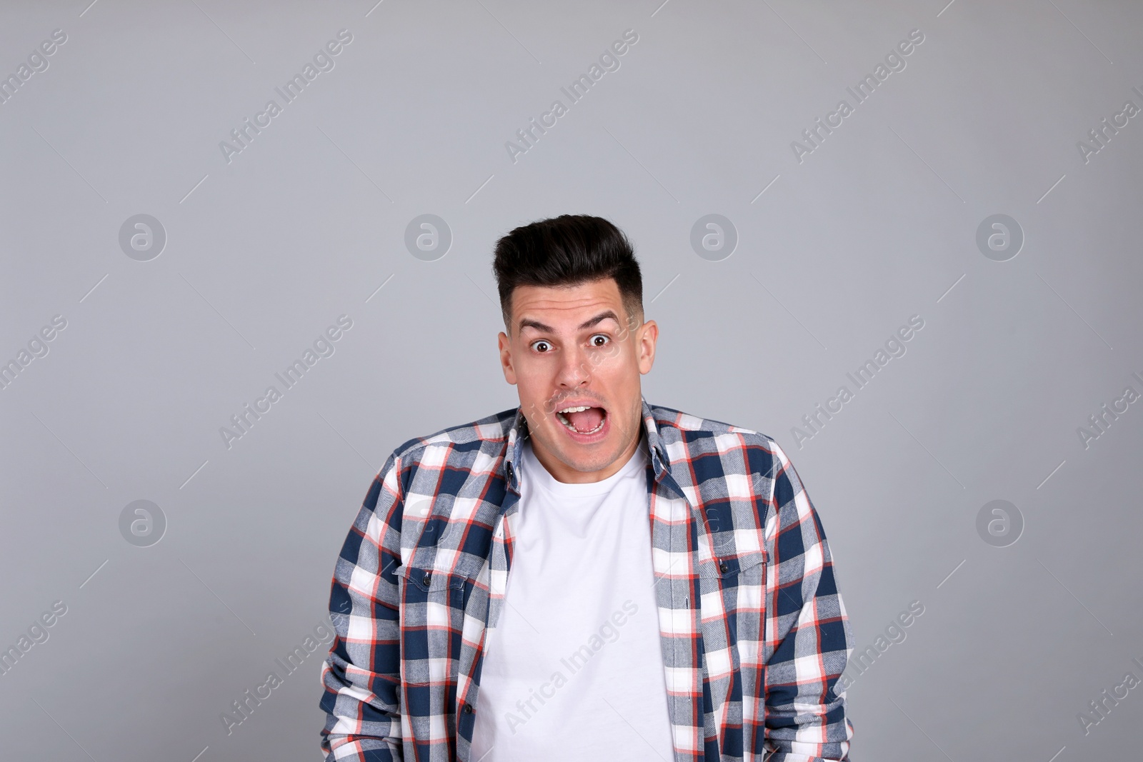 Photo of Portrait of emotional man on light grey background. Personality concept