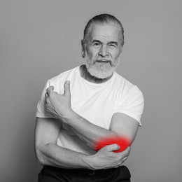 Image of Senior man suffering from rheumatism on light background. Black and white effect with red accent in painful area