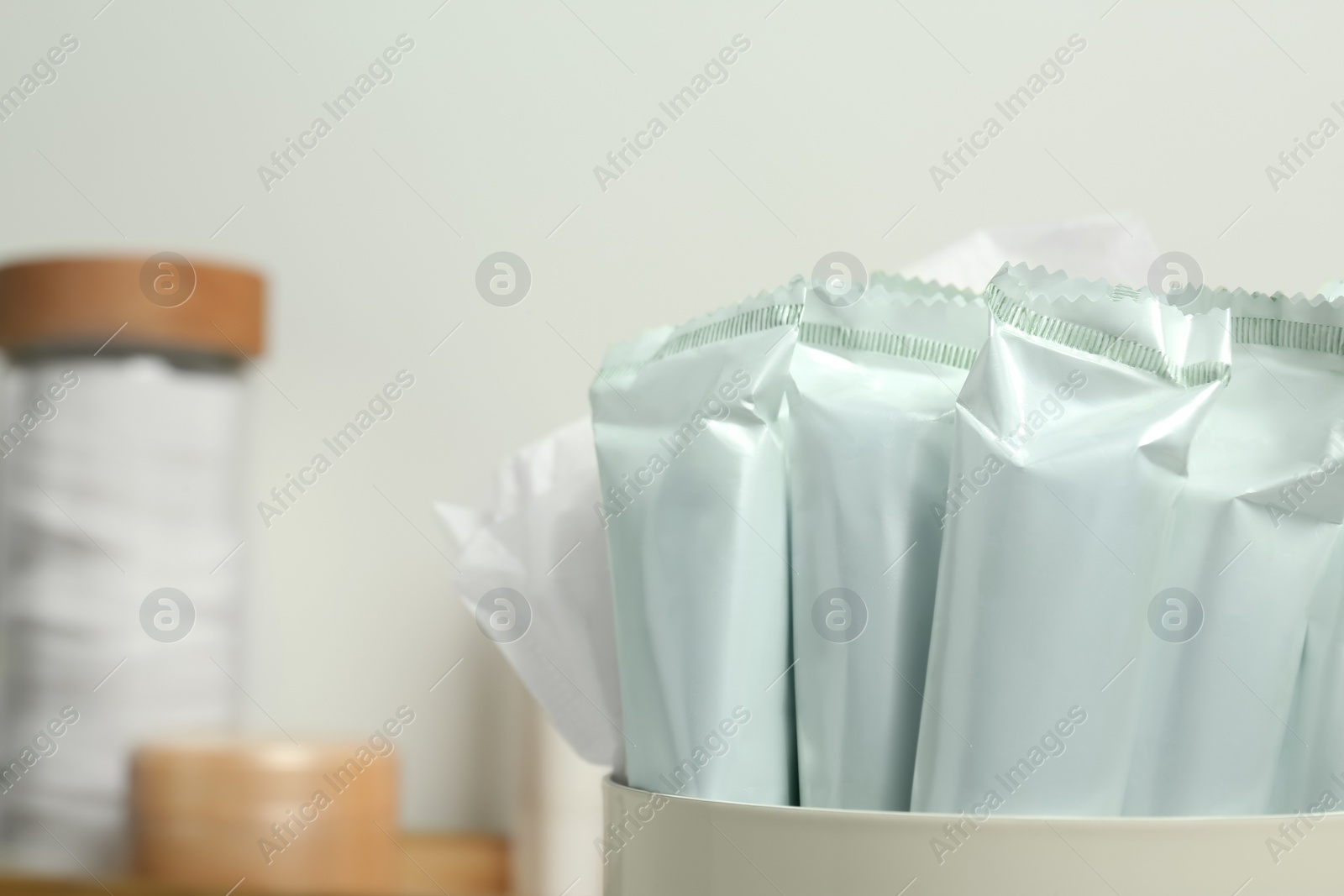 Photo of Closeup view of many tampons in holder, space for text. Menstrual hygienic product