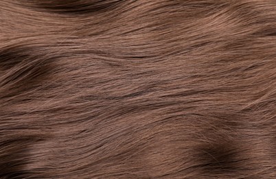 Photo of Beautiful brown hair as background, top view