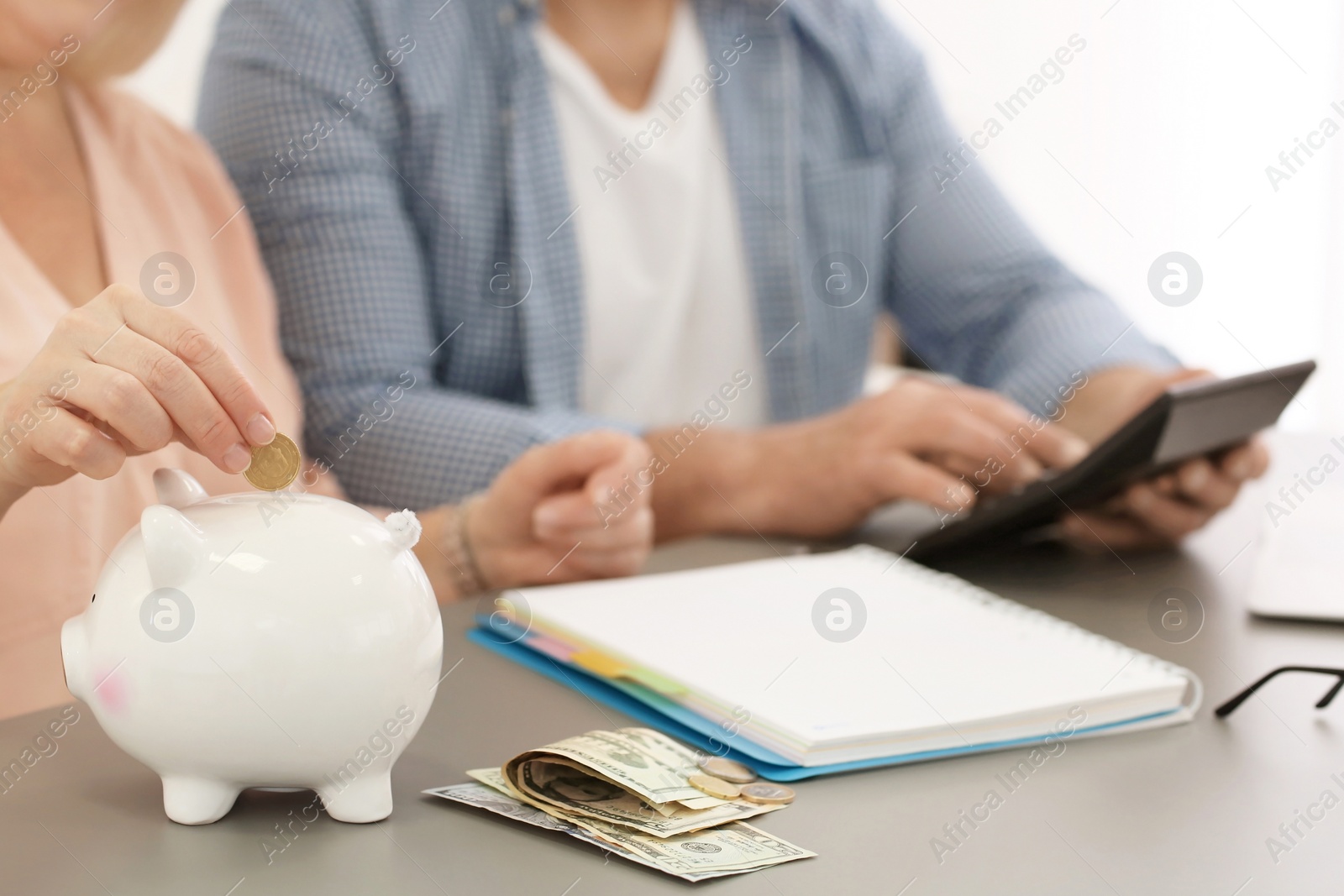 Photo of Mature couple thinking over pension payment at home, closeup