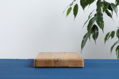 Board on blue wooden table. Space for text