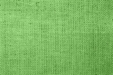 Texture of green burlap fabric as background, top view