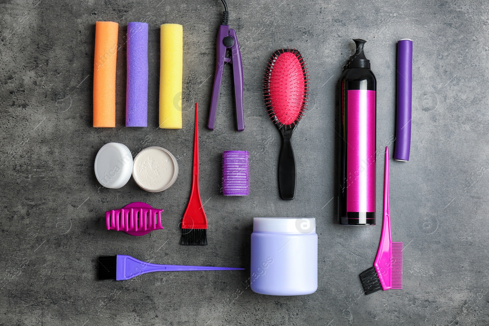 Photo of Flat lay composition with professional hairdresser tools on grey background