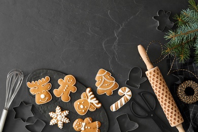 Flat lay composition with delicious homemade Christmas cookies on black table. Space for text