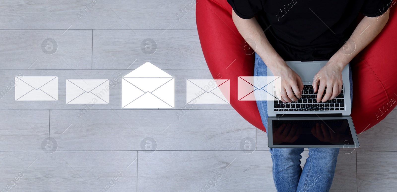 Image of Email. Man using laptop indoors, top view. Letter illustrations over device