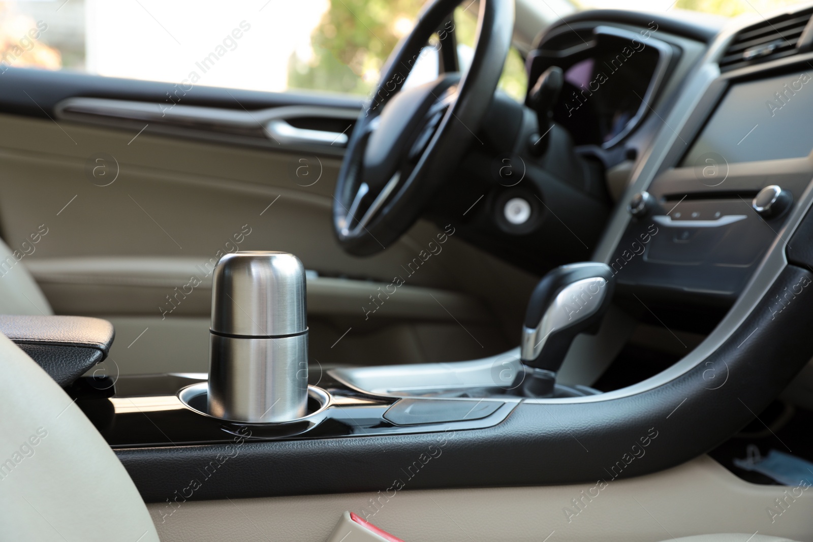 Photo of Silver thermos in holder inside of car