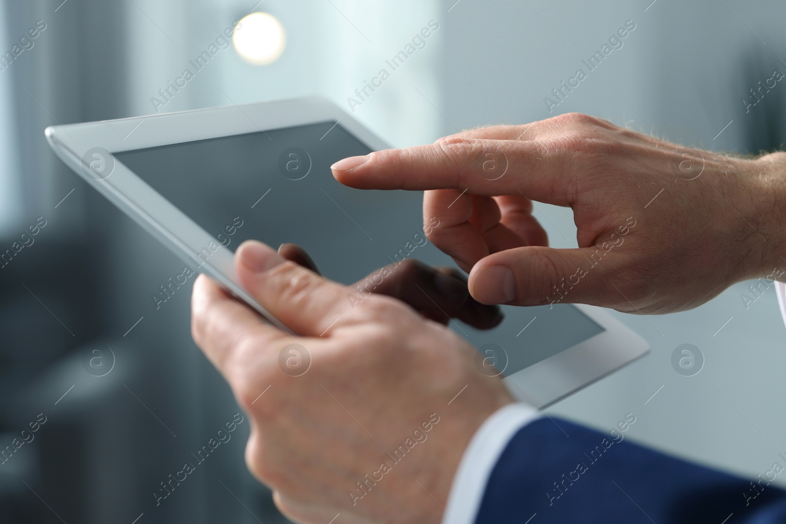 Photo of Closeup view of man using new tablet indoors