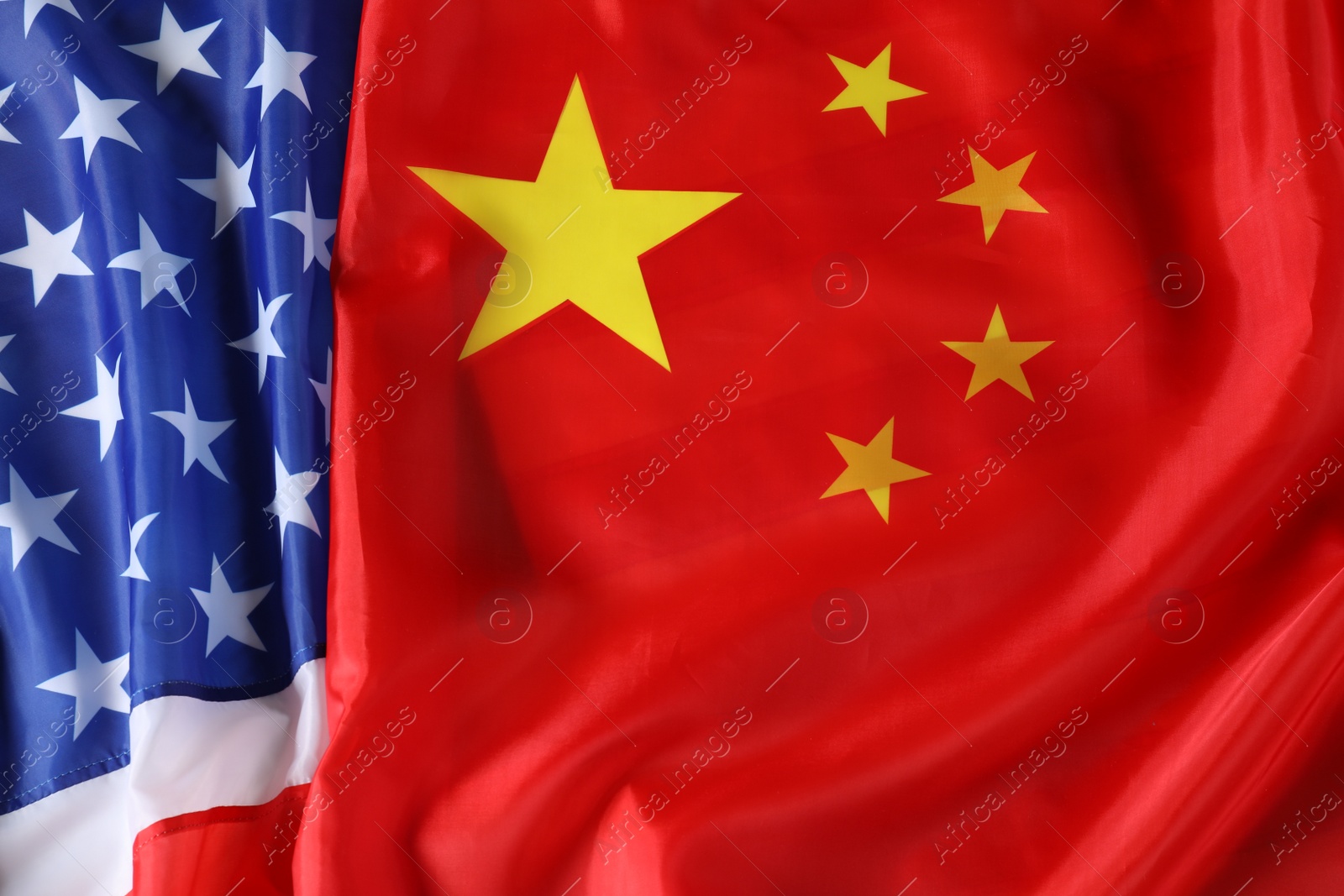 Photo of USA and China flags as background, top view. International relations