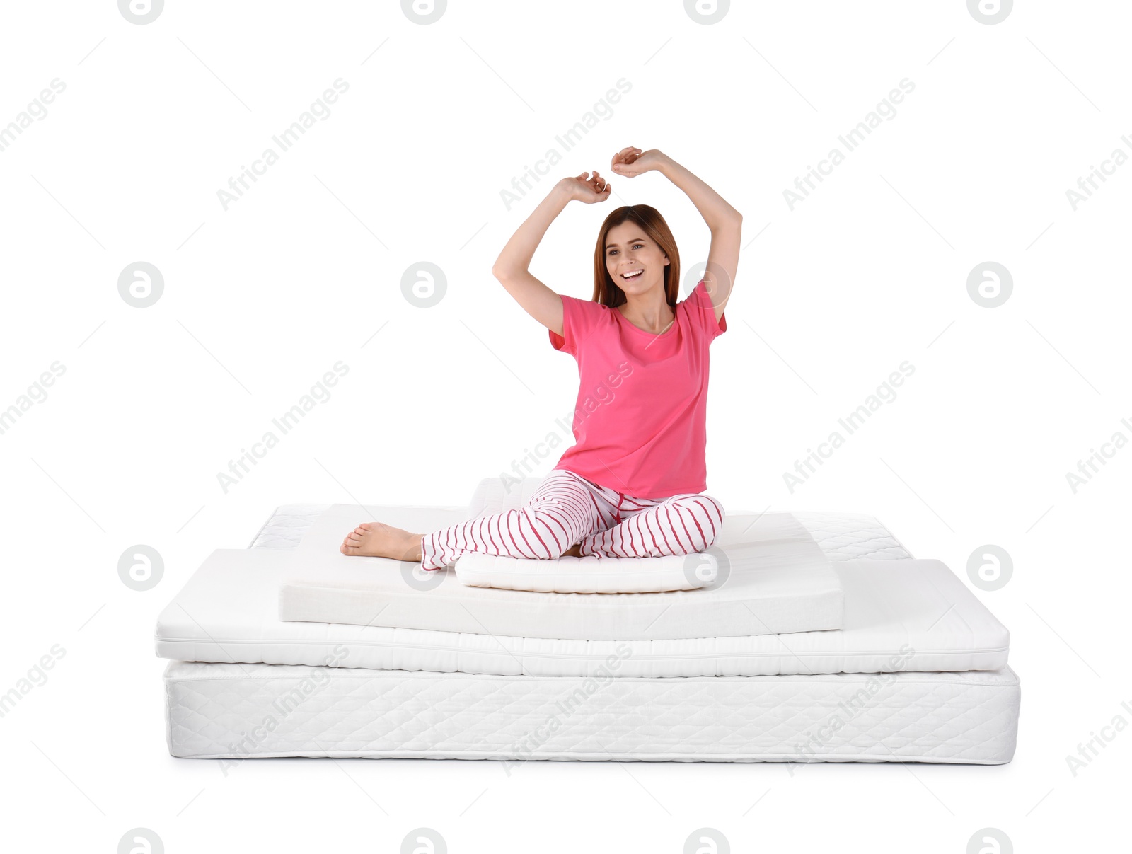 Photo of Woman sitting on mattress pile against white background