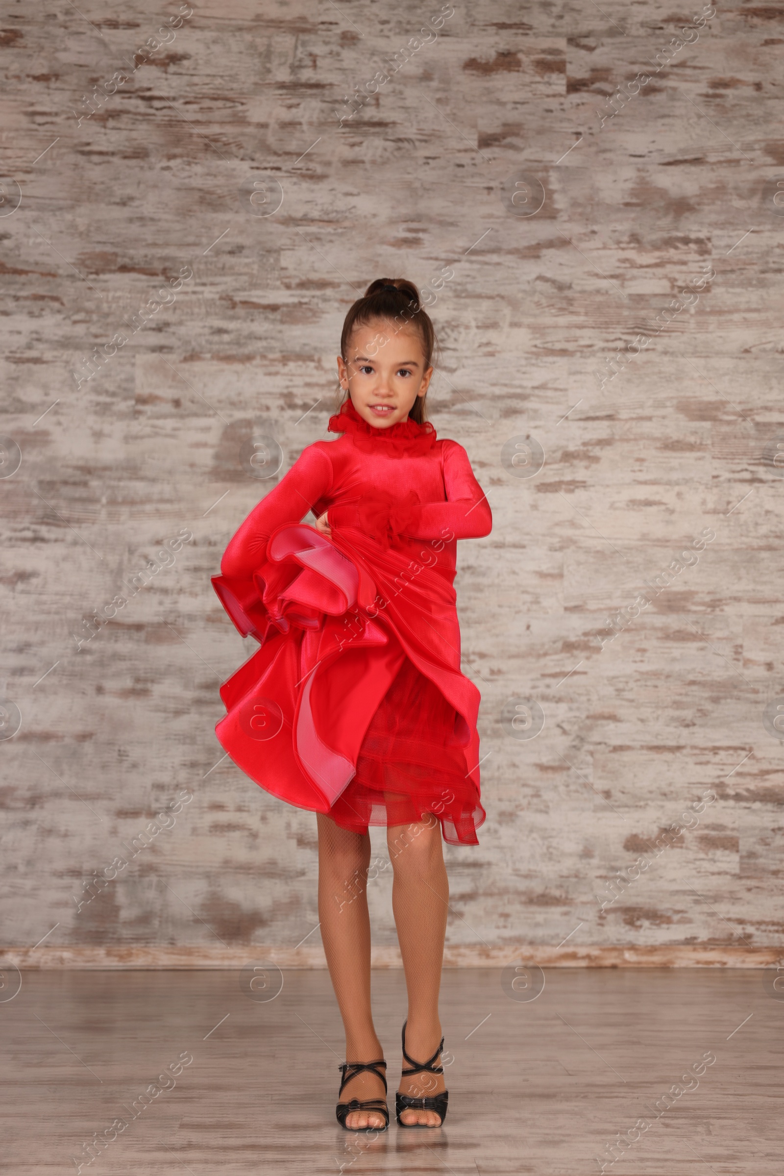 Photo of Beautifully dressed little girl dancing in studio