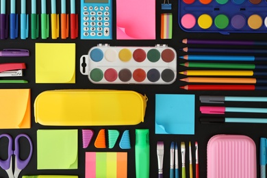 Photo of Different stationery on blackboard, flat lay. Back to school