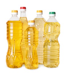 Bottles of cooking oil on white background