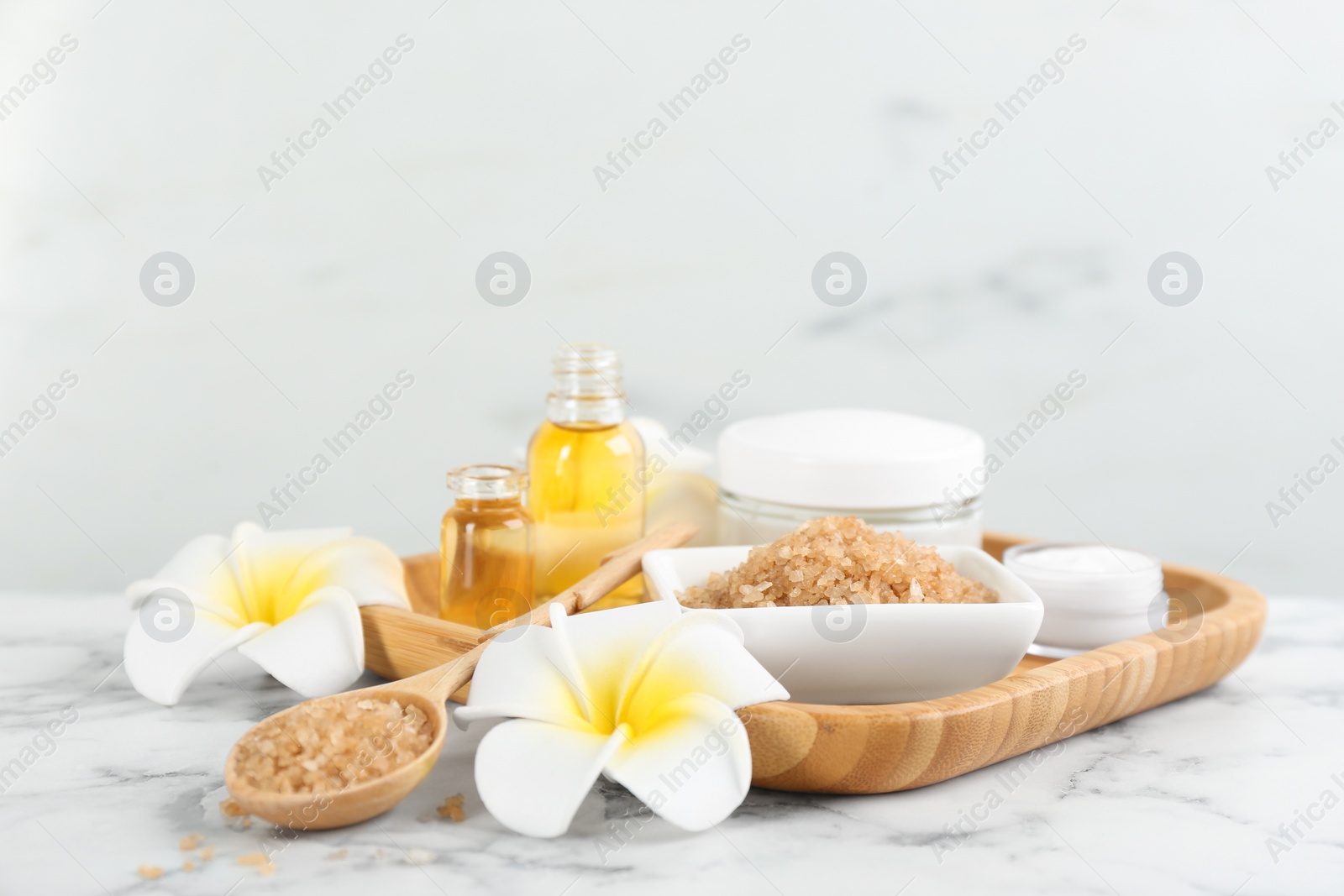 Photo of Beautiful spa composition with sea salt and aroma oil on white marble table