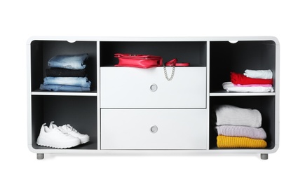 Stylish shelving unit with clothes and shoes on white background. Furniture for wardrobe room