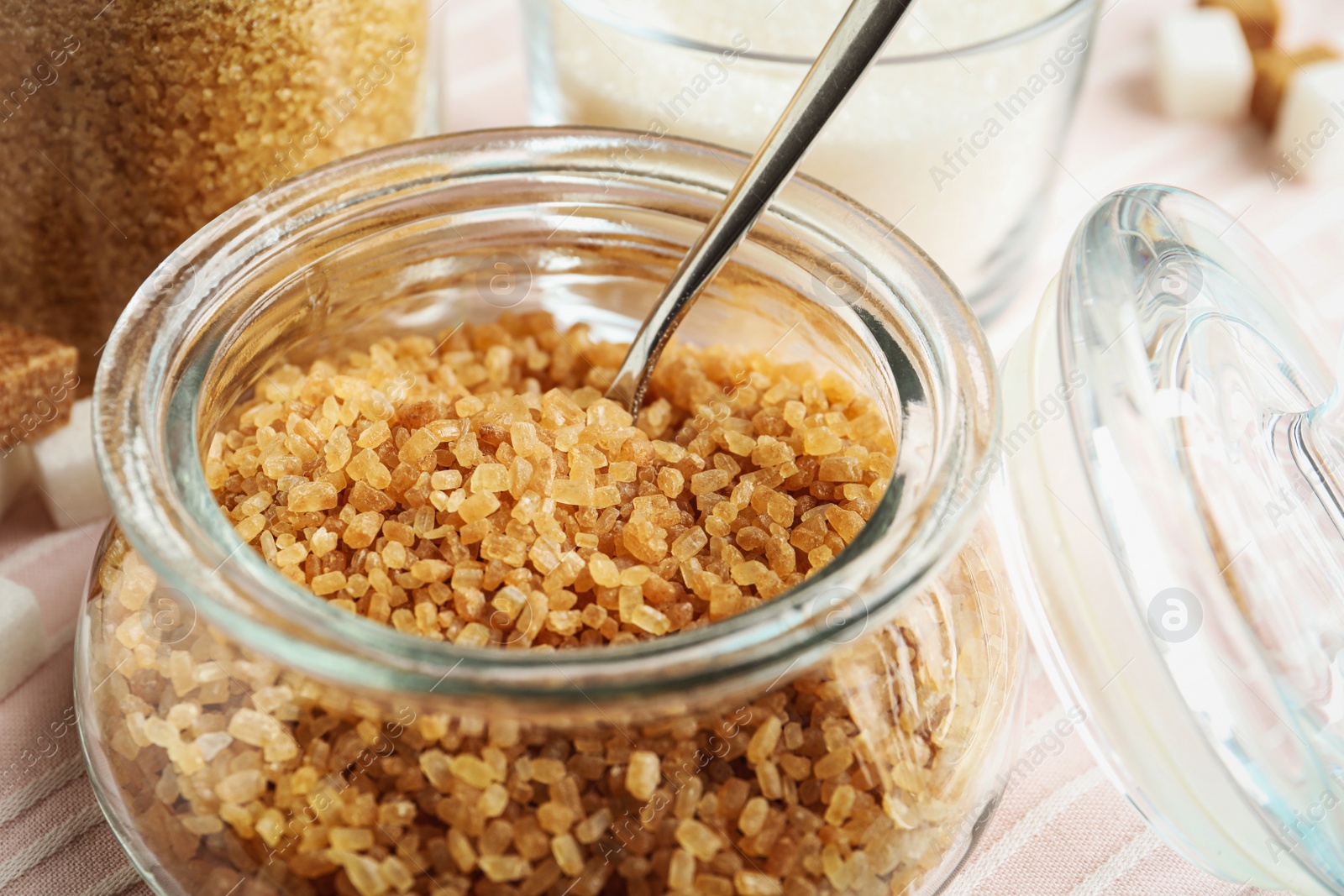 Photo of Glass bowl with brown sugar on table, closeup