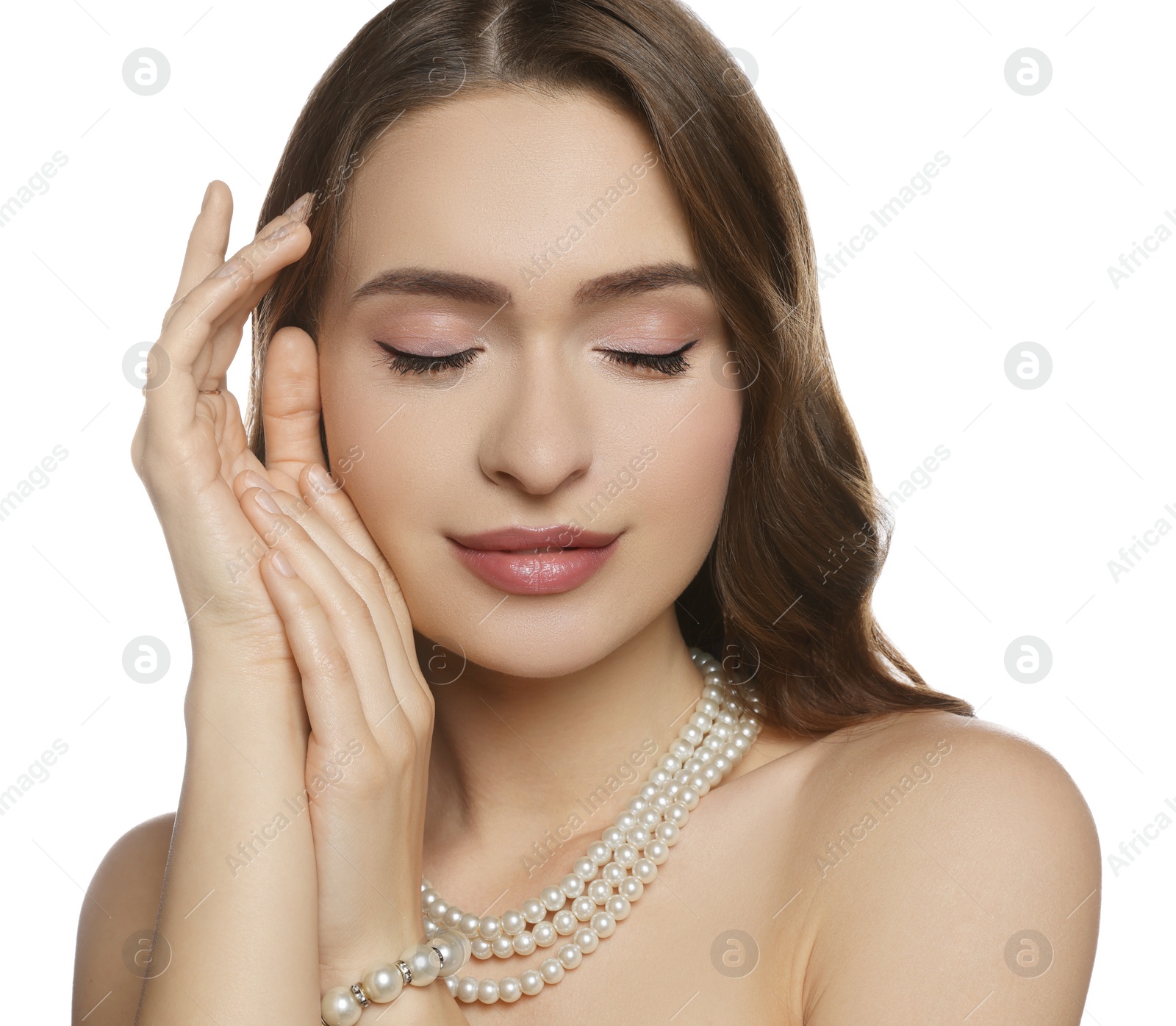 Photo of Young woman with elegant pearl jewelry on white background