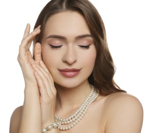 Young woman with elegant pearl jewelry on white background