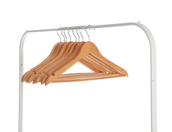 Photo of Wardrobe rack with wooden hangers isolated on white