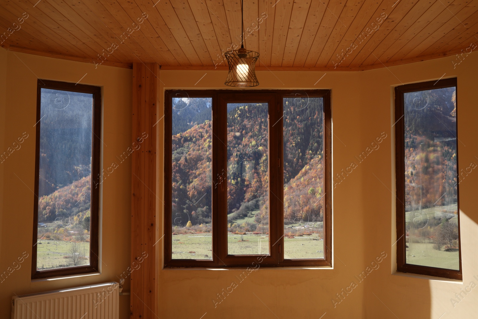 Photo of Empty room with clean windows and beige wall indoors