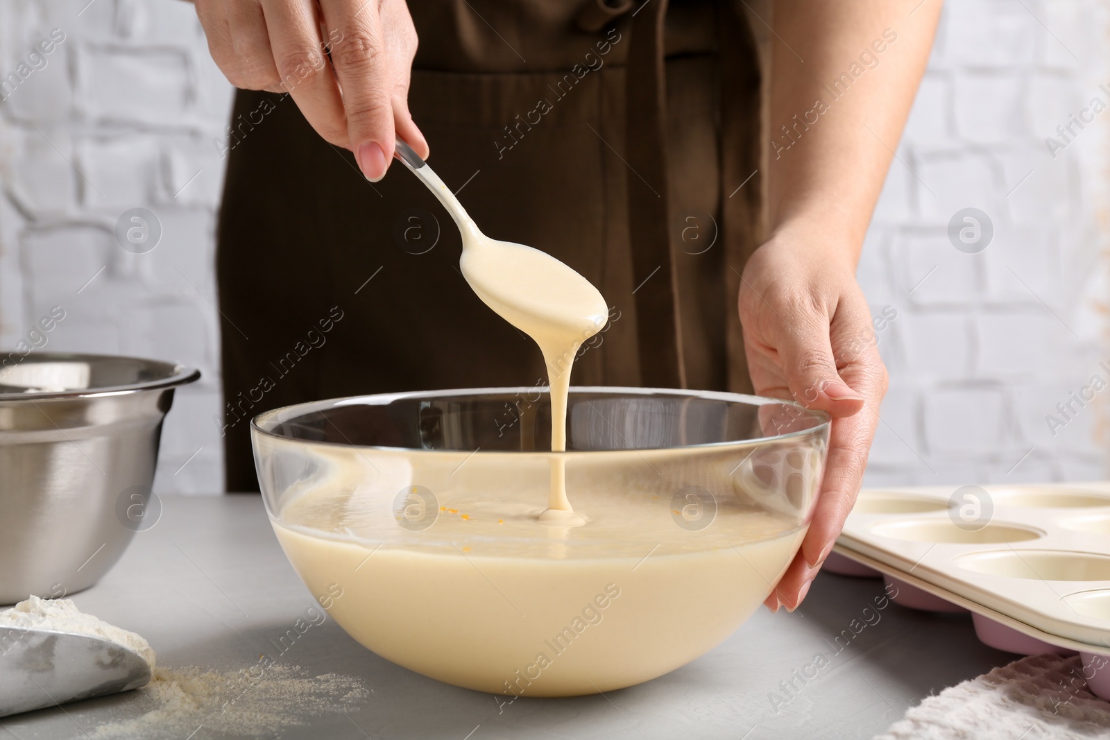 Photo of Woman making batter at light table, closeup