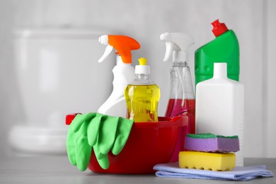 Photo of Set of cleaning supplies on table indoors