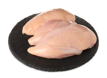 Photo of Slate plate with raw chicken breasts on white background. Fresh meat