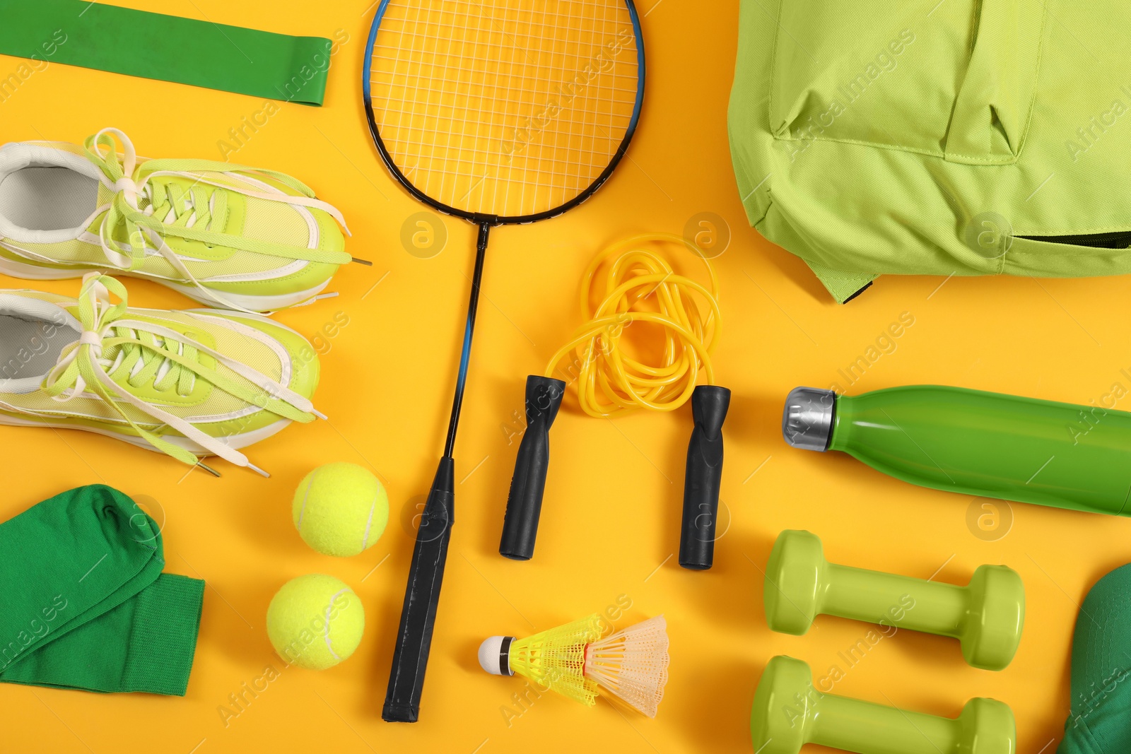 Photo of Different sports equipment on yellow background, flat lay