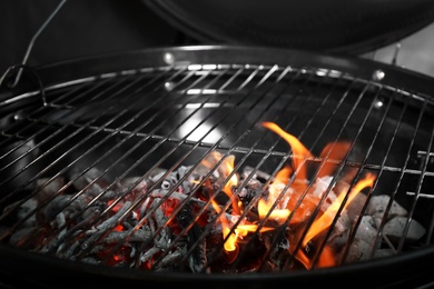 Photo of New modern barbecue grill with coals, closeup