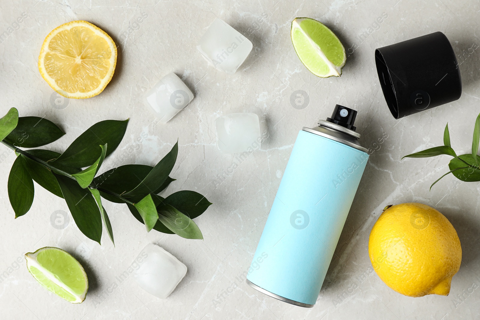 Photo of Flat lay composition with spray deodorant on light grey marble table