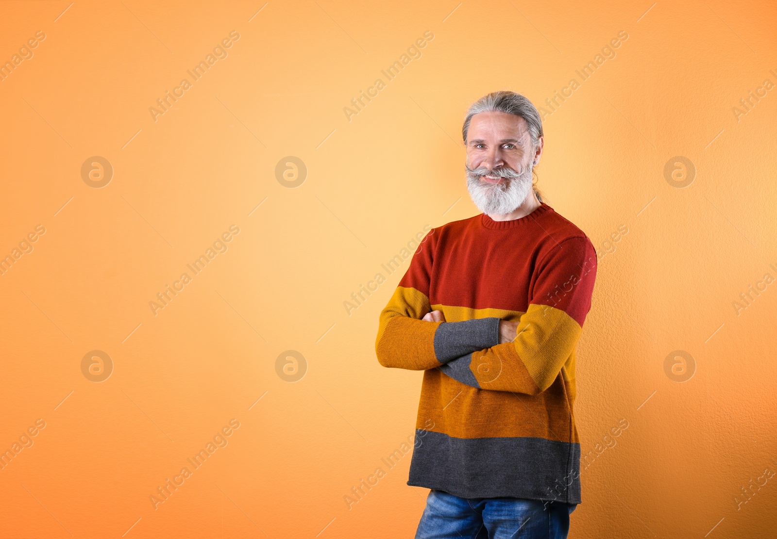 Photo of Portrait of handsome mature man on color background