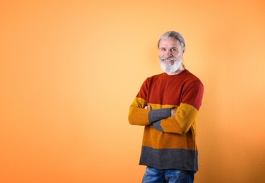 Portrait of handsome mature man on color background