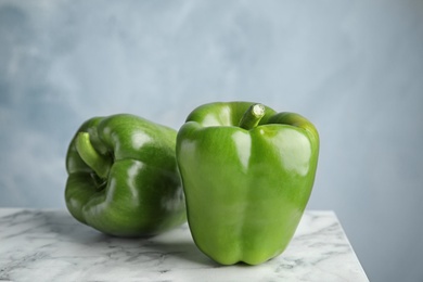 Photo of Raw ripe paprika peppers on marble table