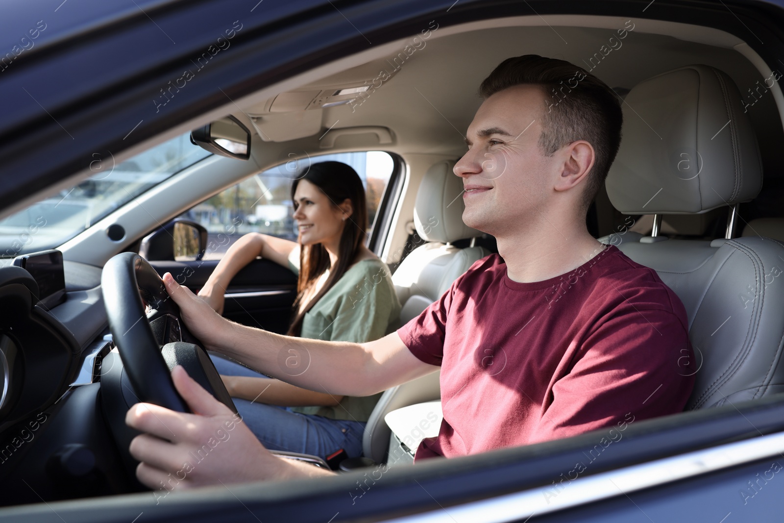 Photo of Happy young couple travelling together by car