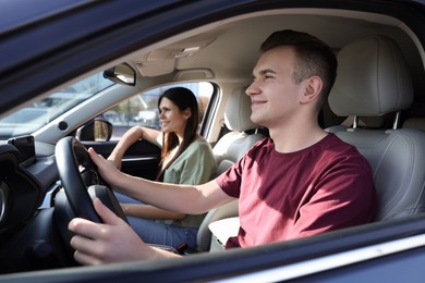 Photo of Happy young couple travelling together by car