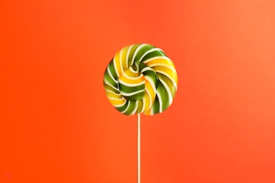 Photo of Bright fruit flavored candy on color background
